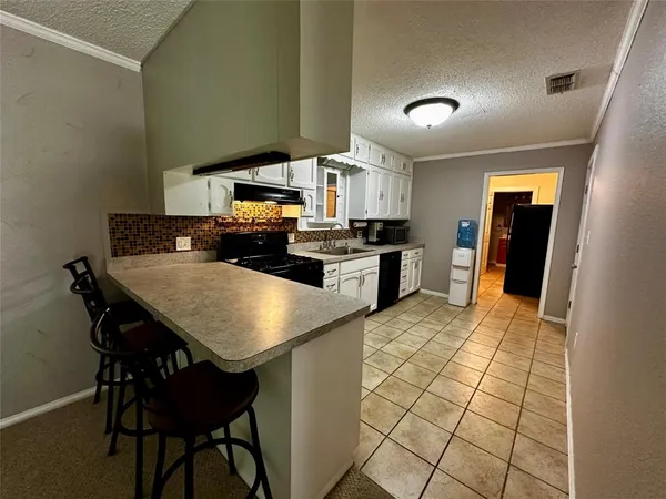 a kitchen with stainless steel appliances granite countertop a sink counter space and cabinets