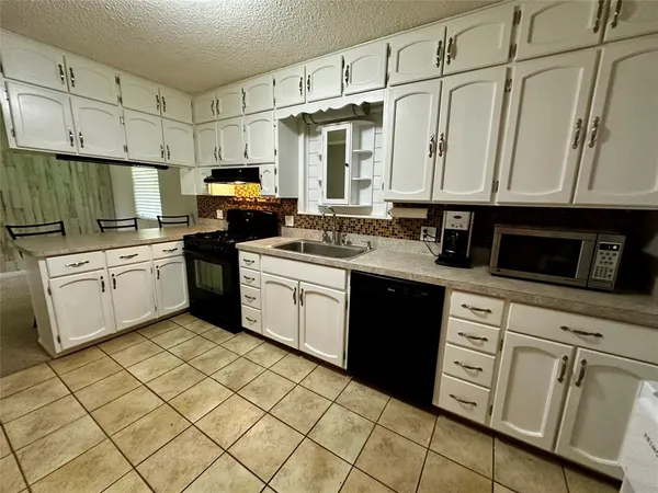 a kitchen with stainless steel appliances granite countertop a sink and cabinets