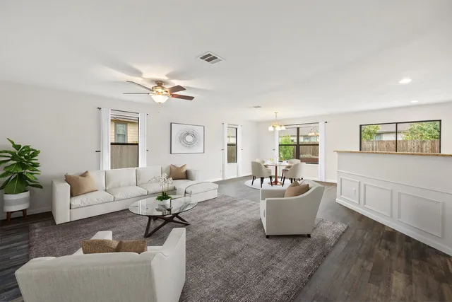 a living room with furniture and a wooden floor