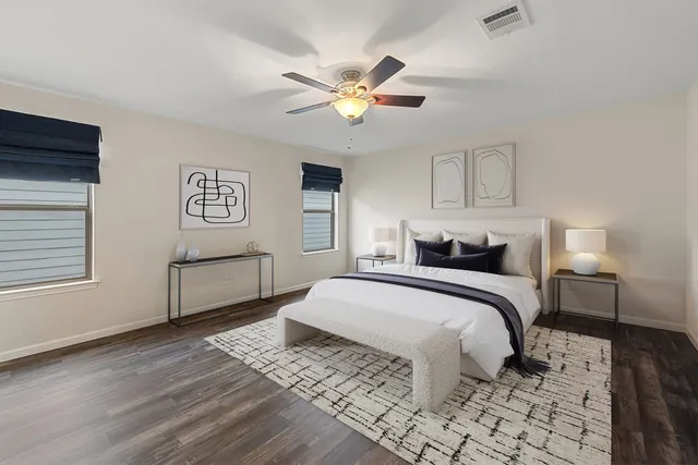 a large kitchen with stainless steel appliances granite countertop a sink and wooden cabinets