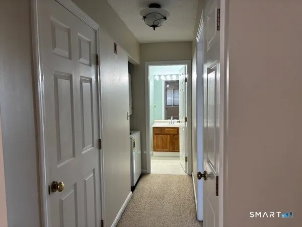 a view of a hallway with a bathroom