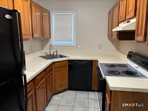 a kitchen with a sink and a refrigerator