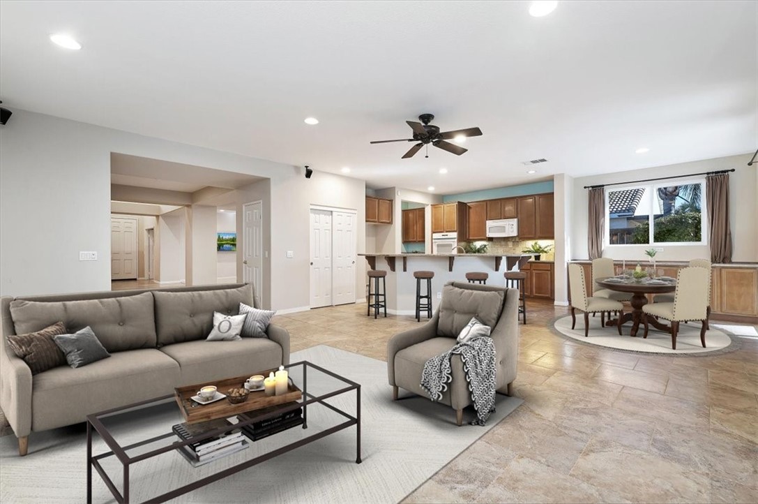19069 Eldorado Road Perris, CA 92570 - Photo 14 of 49 a living room with furniture and a dining table with kitchen view