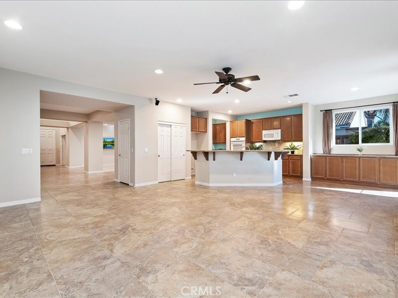 19069 Eldorado Road Perris, CA 92570 - Photo 15 of 49 a view of a livingroom with furniture and a kitchen