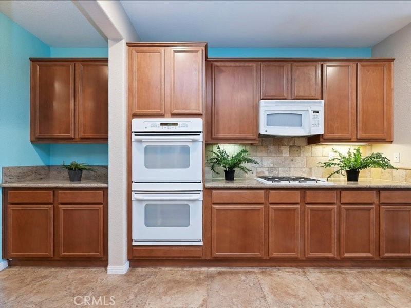 19069 Eldorado Road Perris, CA 92570 - Photo 19 of 49 a kitchen with granite countertop cabinets stainless steel appliances and a counter space