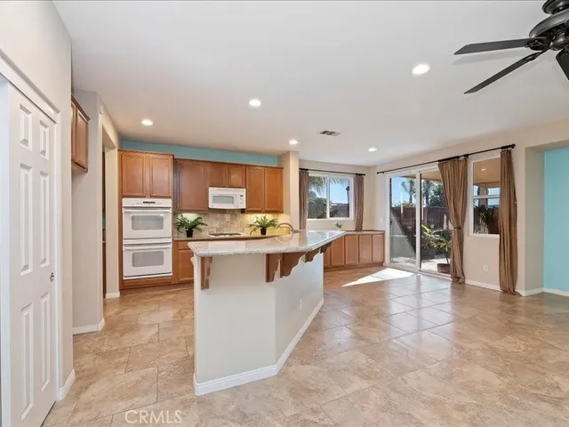a kitchen with kitchen island a sink and a stove top oven