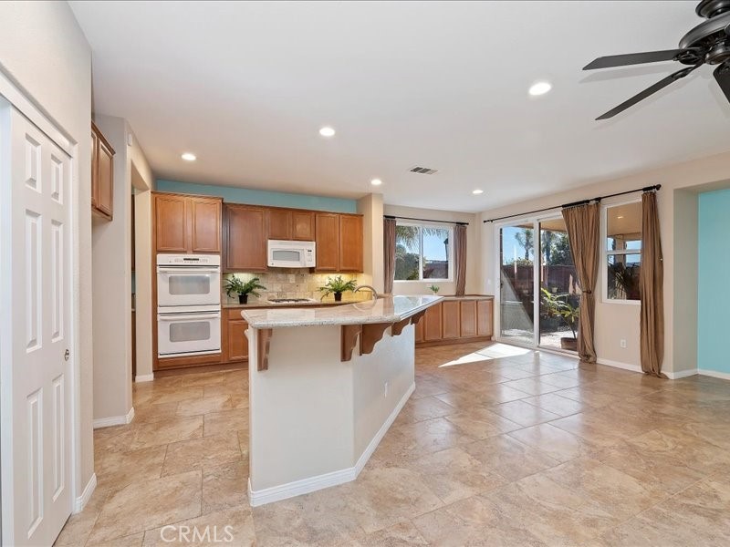 19069 Eldorado Road Perris, CA 92570 - Photo 20 of 49 a kitchen with white cabinets and refrigerator