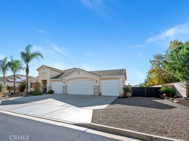 19069 Eldorado Road Perris, CA 92570 - Photo 2 of 49 a front view of a house with a yard and garage