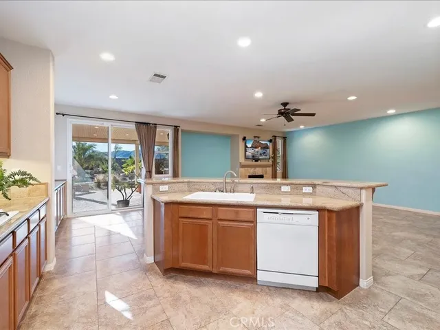 a view of a kitchen with a sink and cabinets