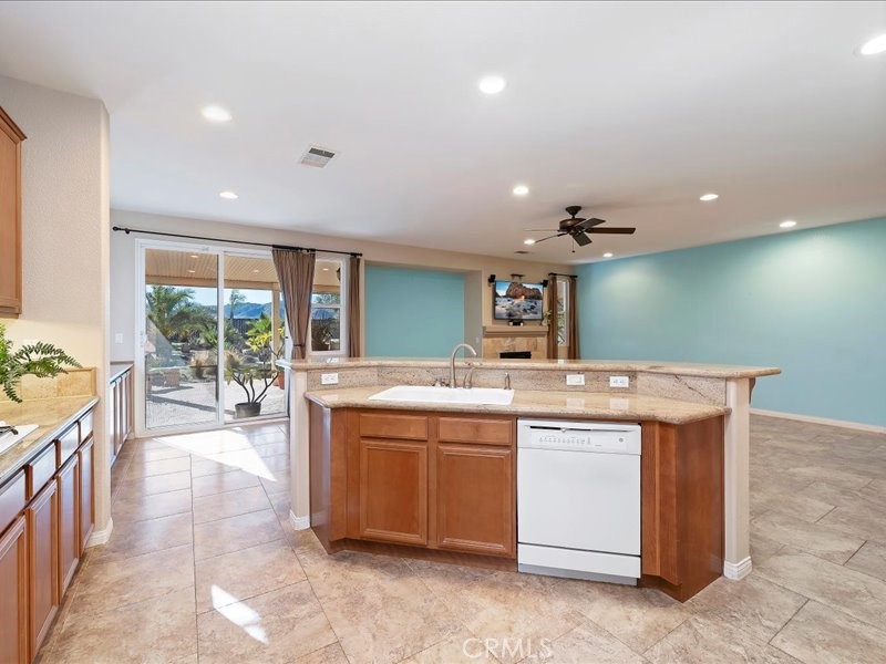 19069 Eldorado Road Perris, CA 92570 - Photo 21 of 49 a kitchen with kitchen island a sink and a stove top oven