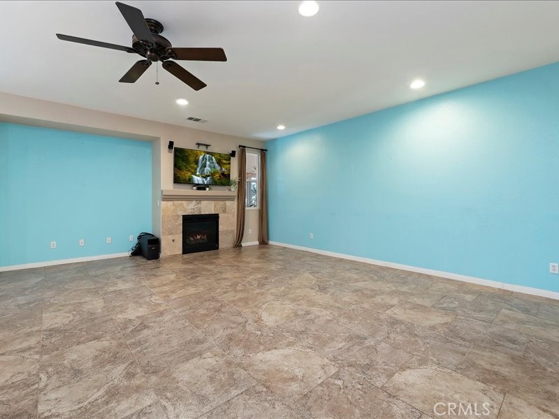 19069 Eldorado Road Perris, CA 92570 - Photo 25 of 49 an empty room with fireplace and window