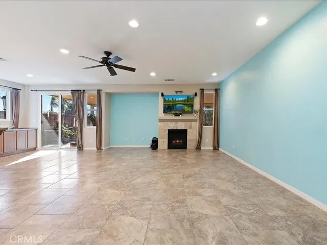 a view of a livingroom with a ceiling fan and window