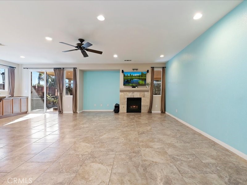 19069 Eldorado Road Perris, CA 92570 - Photo 26 of 49 a view of an empty room with a fireplace and a window