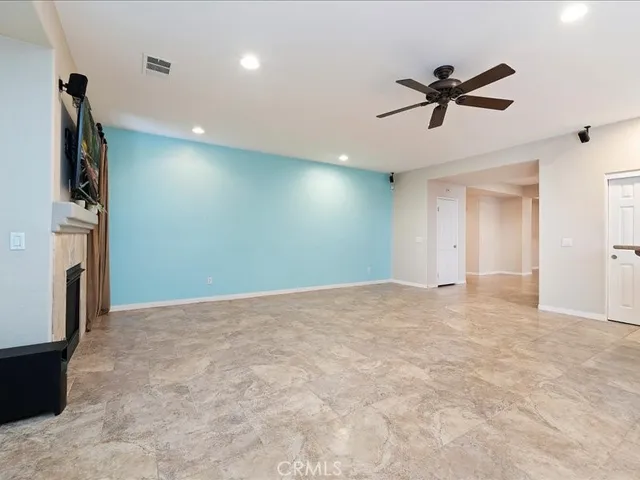a view of a livingroom with a ceiling fan and window