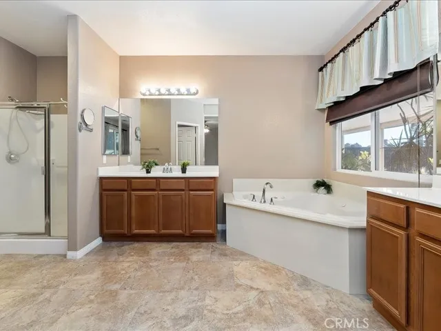 a bathroom with a bathtub sink and mirror
