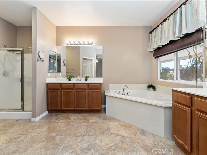 19069 Eldorado Road Perris, CA 92570 - Photo 31 of 49 a large bathroom with a large tub sink and double vanity