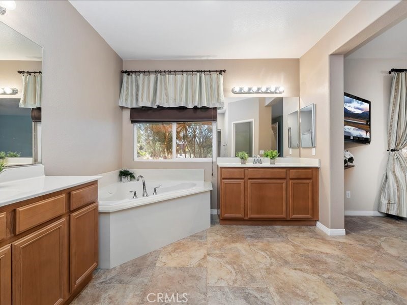 19069 Eldorado Road Perris, CA 92570 - Photo 32 of 49 a bathroom with a bathtub sink and mirror