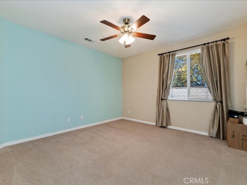 19069 Eldorado Road Perris, CA 92570 - Photo 34 of 49 an empty room with ceiling fan and windows