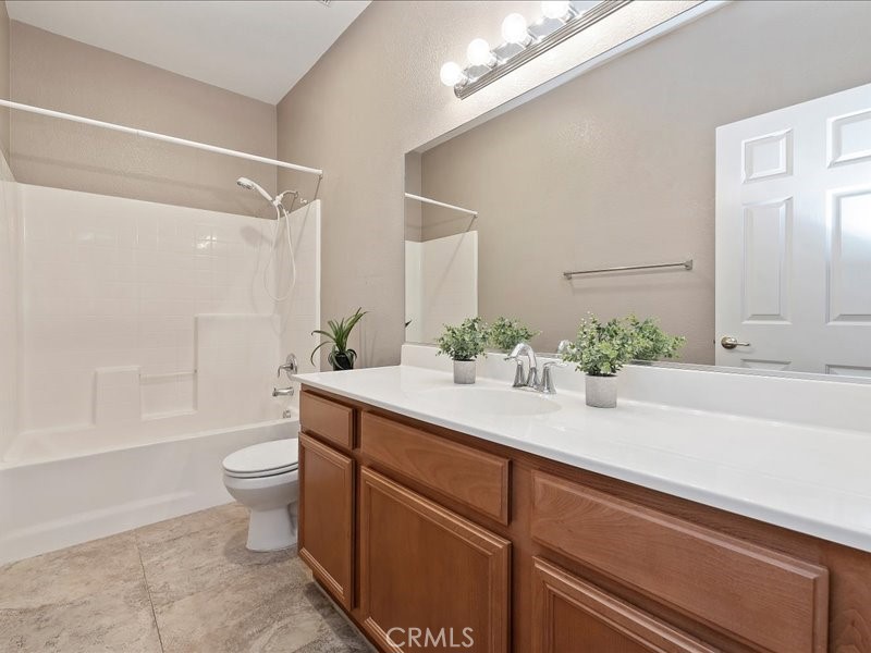 19069 Eldorado Road Perris, CA 92570 - Photo 35 of 49 a bathroom with a sink a toilet and shower