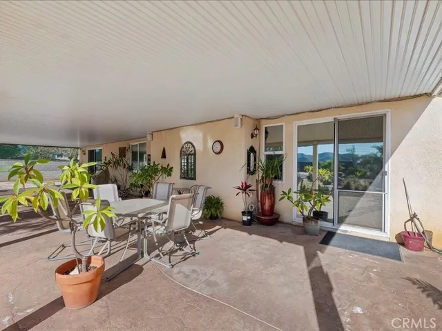 a view of a backyard with table and chairs