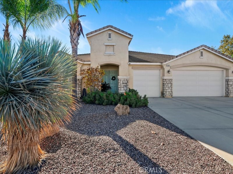 19069 Eldorado Road Perris, CA 92570 - Photo 4 of 49 a front view of a house with a yard