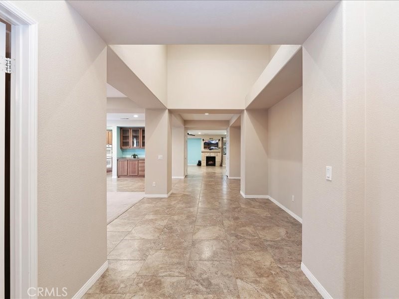 19069 Eldorado Road Perris, CA 92570 - Photo 6 of 49 a view of a hallway with wooden floor and a kitchen