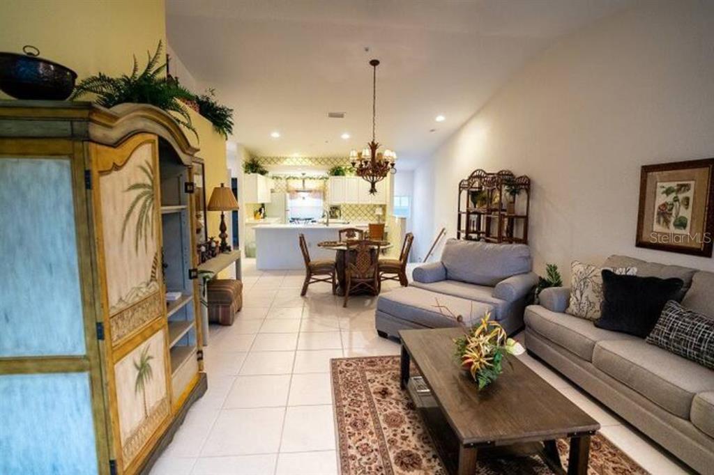 7189 Strand Circle, Unit 1 Bradenton, FL 34203 - Photo 2 of 19 a living room with furniture and a chandelier