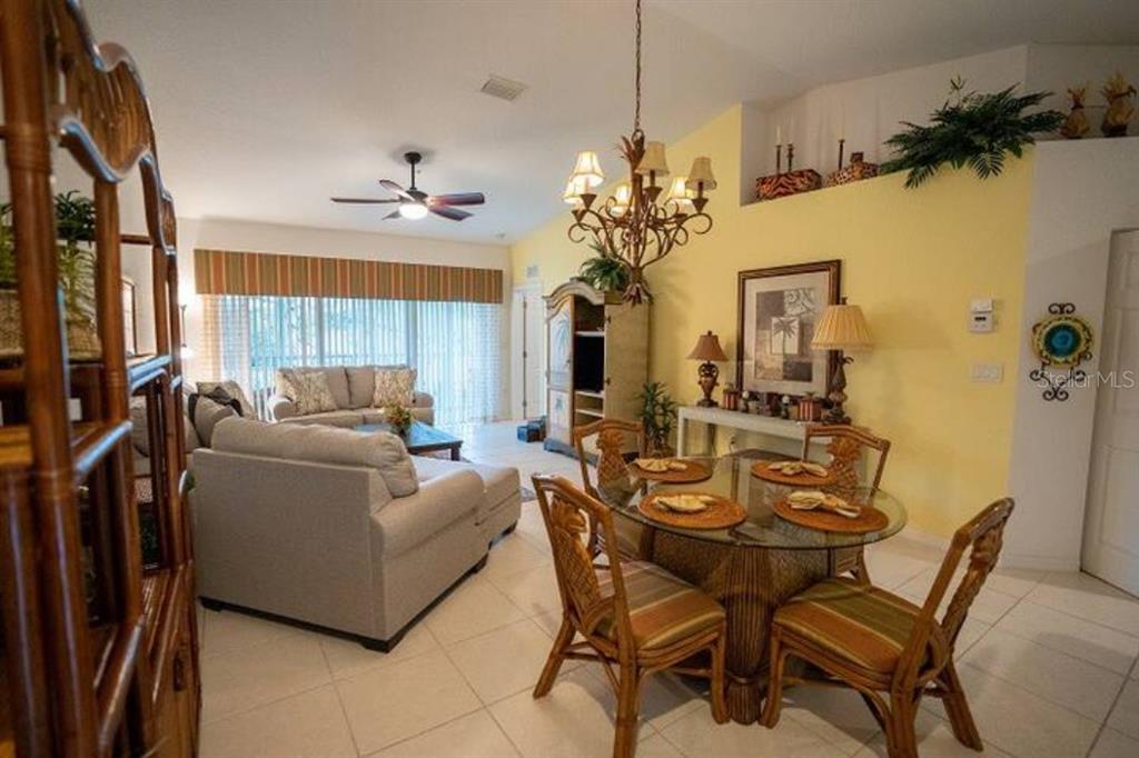 7189 Strand Circle, Unit 1 Bradenton, FL 34203 - Photo 5 of 19 a living room with furniture a chandelier and a chandelier