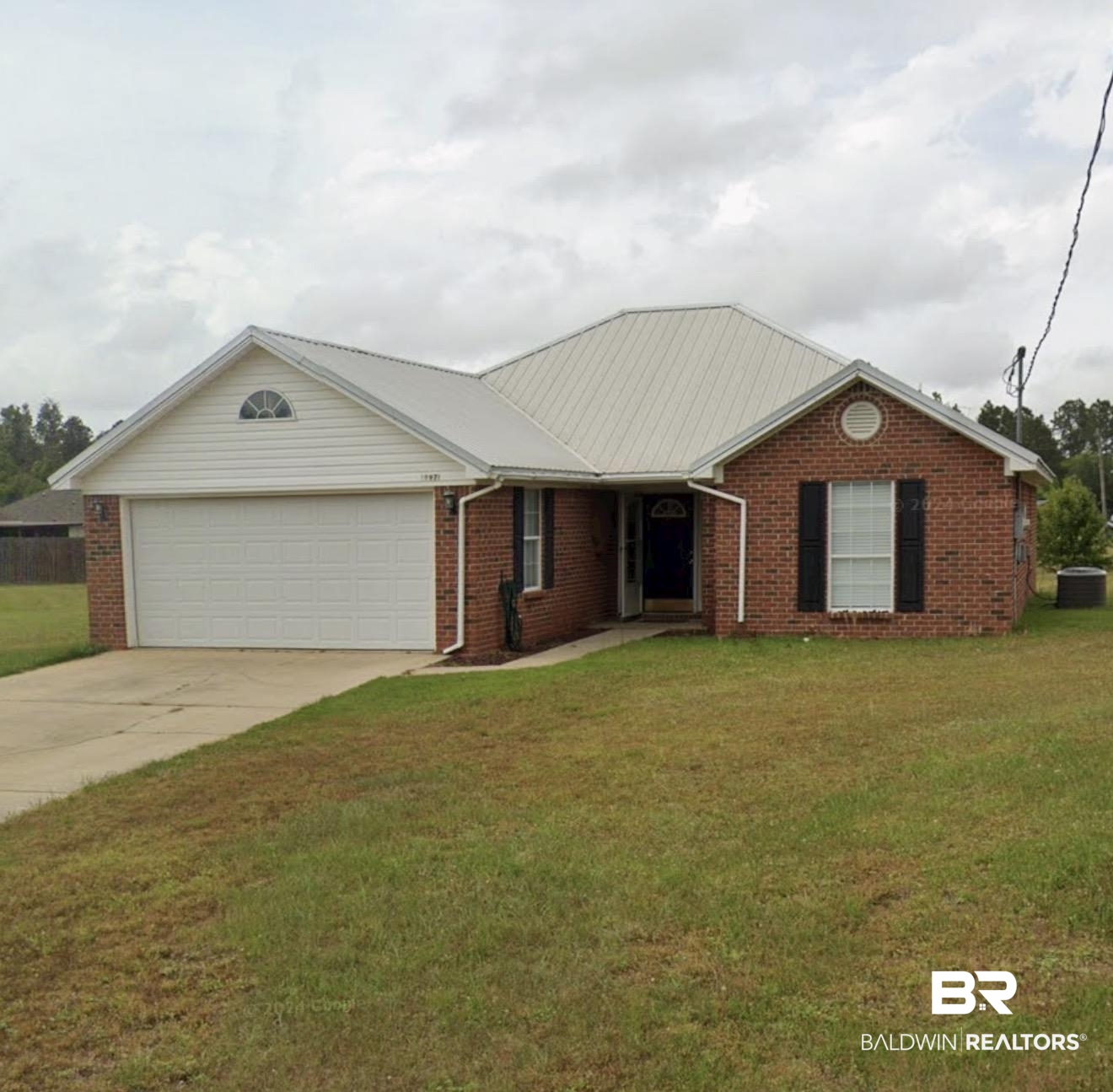 12971 Labradors Run Foley, AL 36535 - Photo 1 of 23 Brick exterior with a light-colored metal roof and white vinyl siding accents