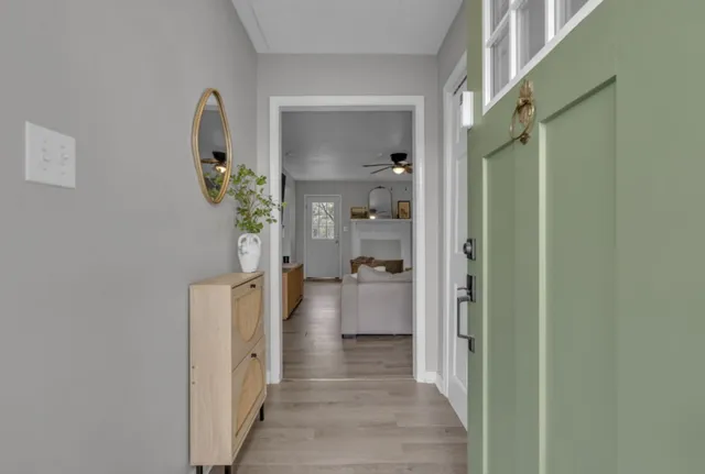 a view of a hallway with wooden shelves