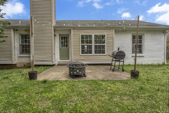 a front view of a house with garden and patio