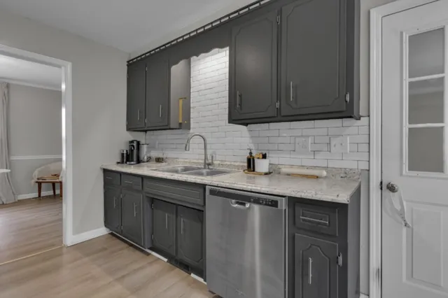 a kitchen with stainless steel appliances granite countertop a sink stove and cabinets