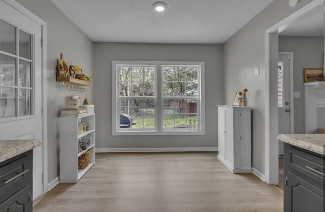 a view of an empty room with a kitchen