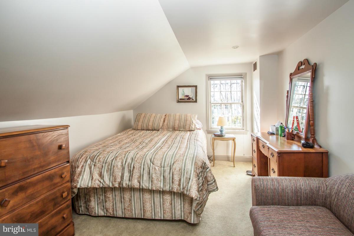315 Farmhouse Road Accokeek, MD 20607 - Photo 12 of 30 a bedroom with a bed and glass window