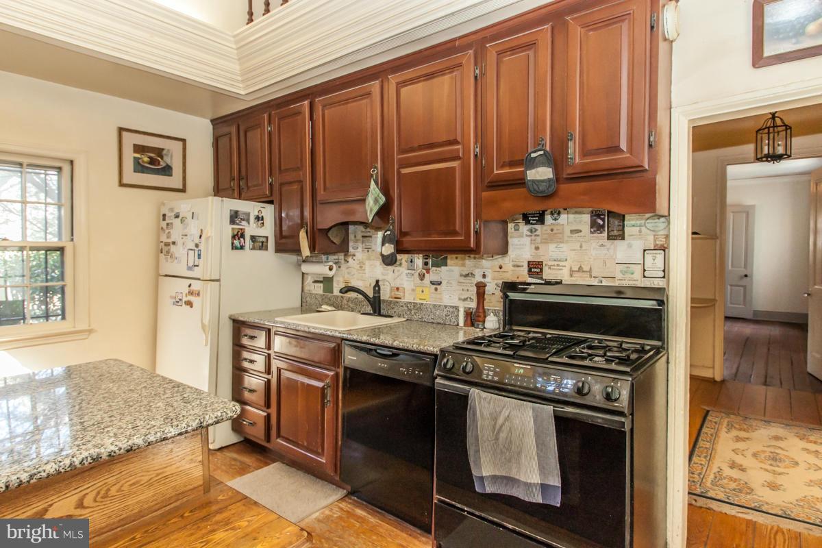 315 Farmhouse Road Accokeek, MD 20607 - Photo 7 of 30 a kitchen with stainless steel appliances granite countertop a stove a sink and a refrigerator