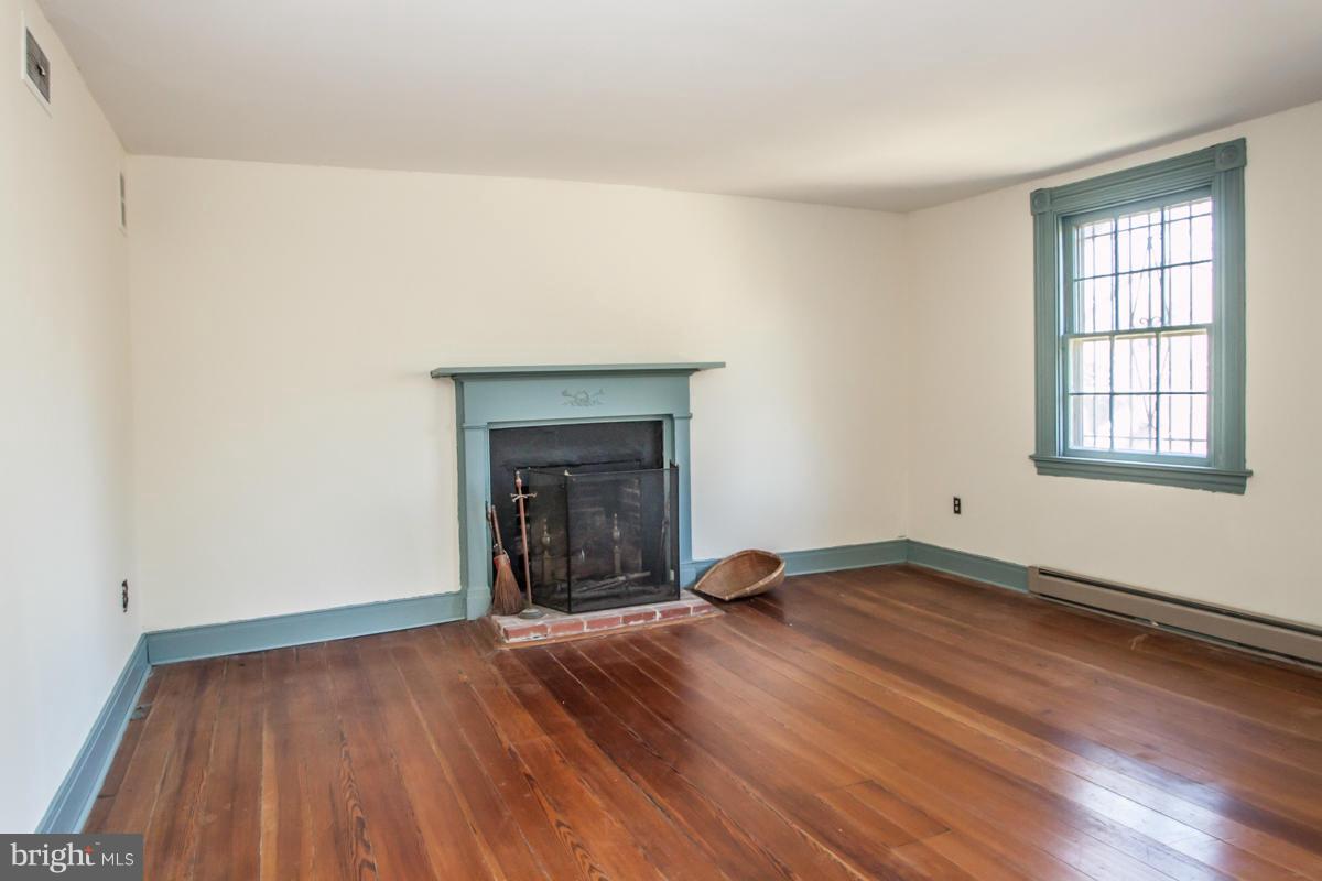 315 Farmhouse Road Accokeek, MD 20607 - Photo 10 of 30 an empty room with wooden floor and windows