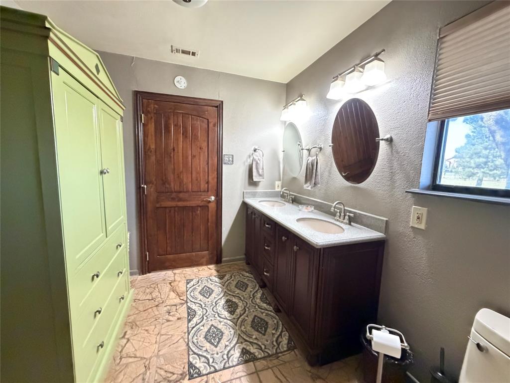 330 South Goode Road Wilmer, TX 75172 - Photo 24 of 38 a bathroom with a sink and a mirror