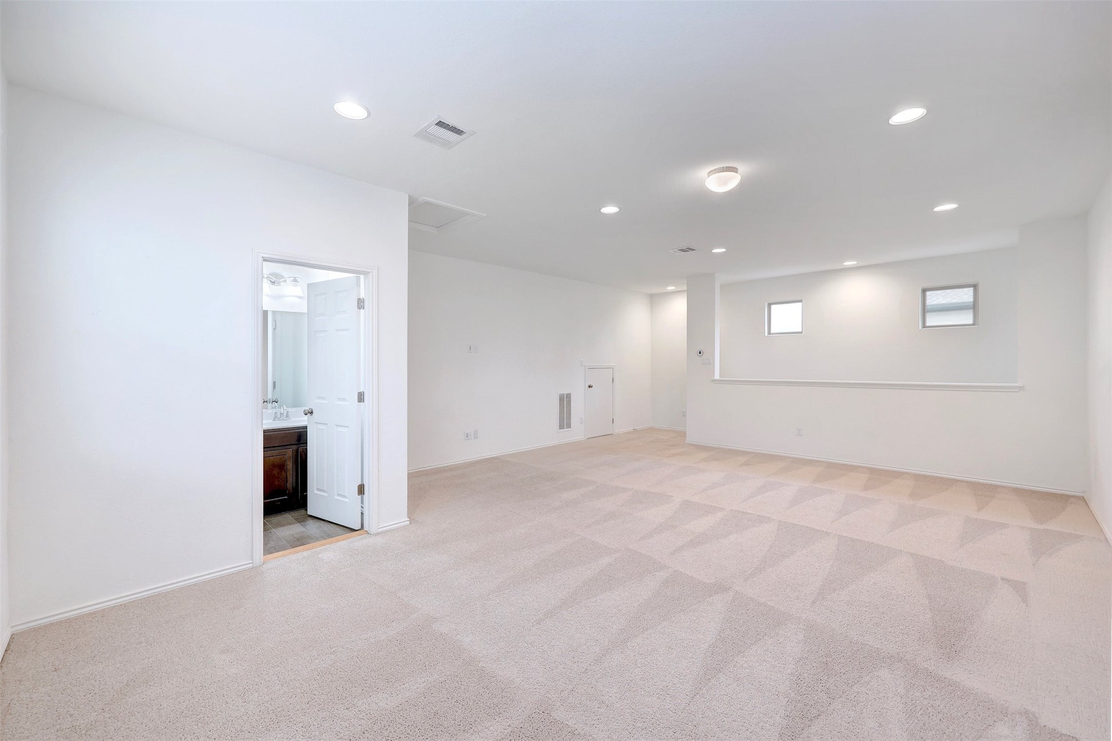 307 Simmental Loop Hutto, TX 78634 - Photo 26 of 34 A spacious room offers comfortable carpeted flooring and abundant recessed lighting.