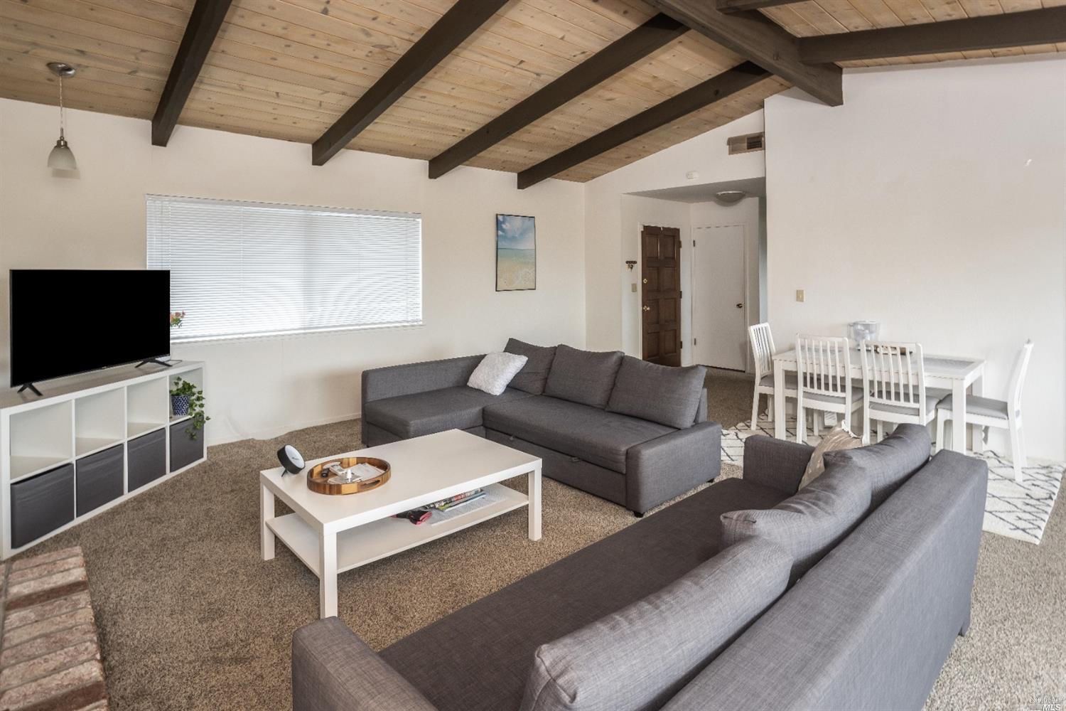 32-34 Reservoir Road San Rafael, CA 94901 - Photo 1 of 1 a living room with furniture and a flat screen tv