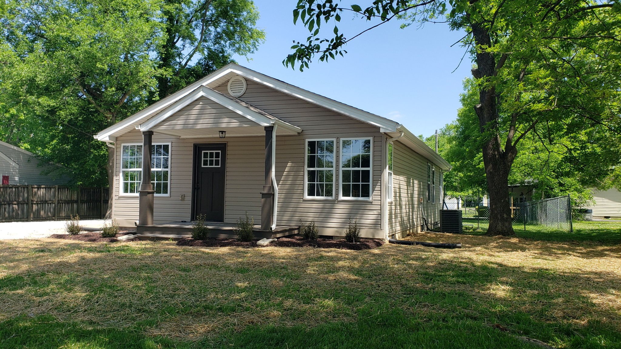 a view of front house with yard and green space