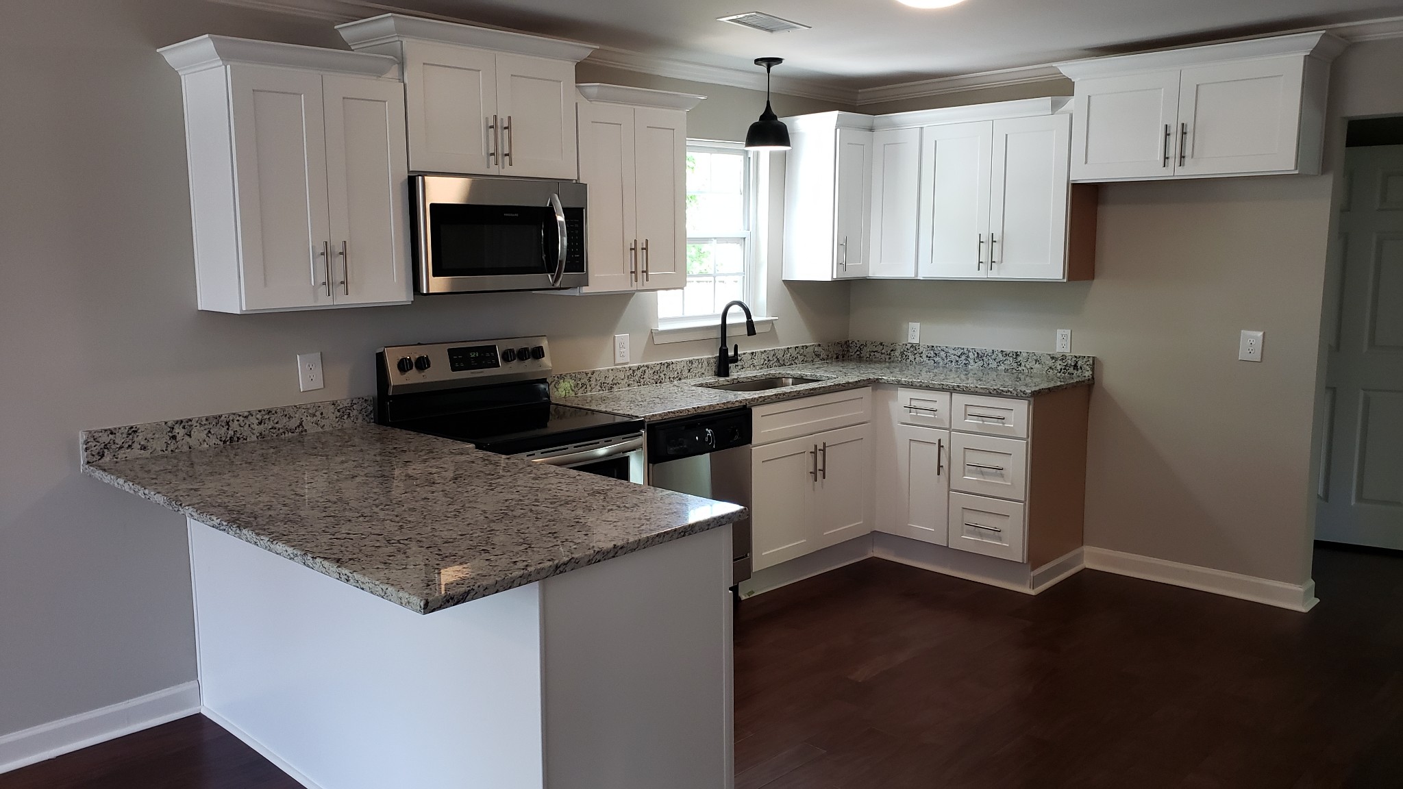 1103 Hickory Ridge Road Lebanon, TN 37087 - Photo 2 of 9 a kitchen with stainless steel appliances granite countertop a sink stove and microwave