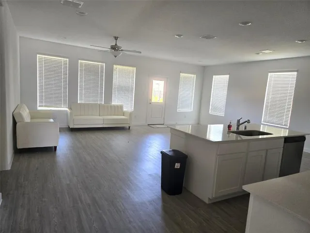 a view of a swimming pool with outdoor seating and plants
