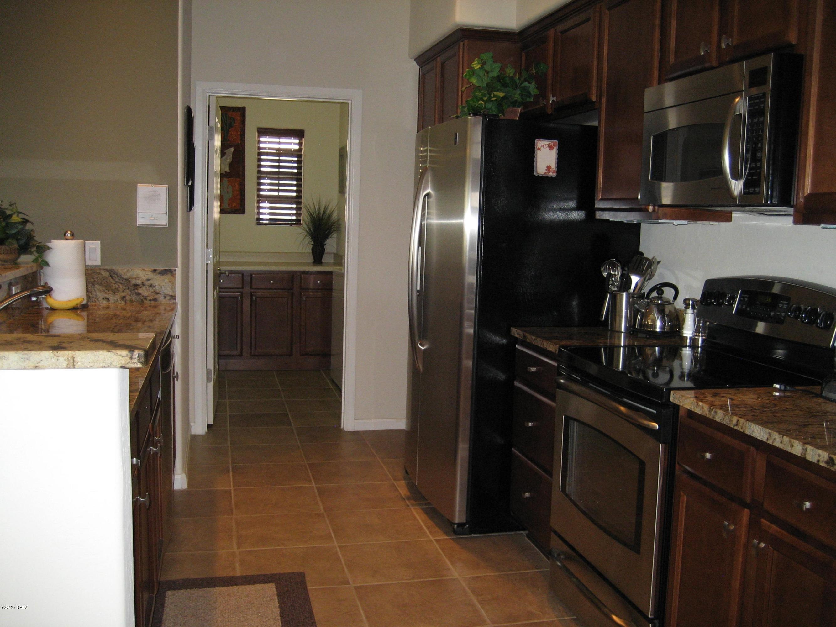 3935 East Rough Rider Road, Unit 1109 Phoenix, AZ 85050 - Photo 9 of 29 Kitchen toward Laundry