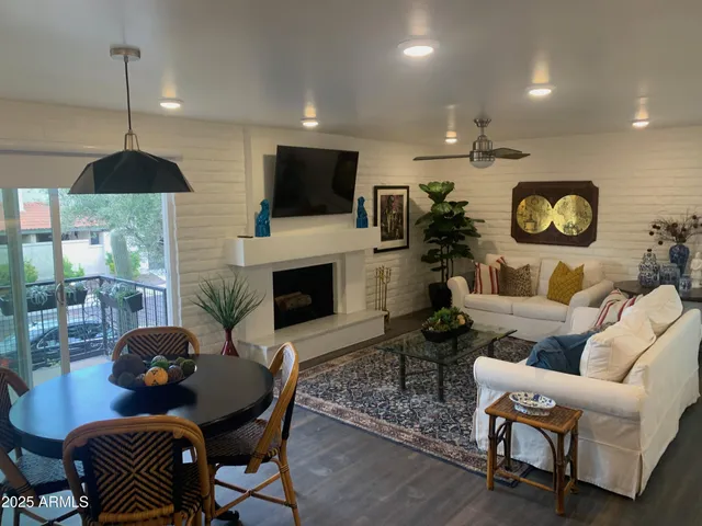 a living room with fireplace furniture and a flat screen tv