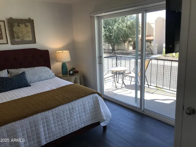 a bedroom with a large bed and a large window