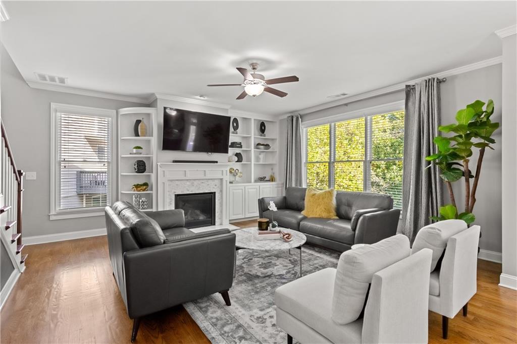 2199 Collins Ridge Drive Northwest Atlanta, GA 30318 - Photo 11 of 50 a living room with furniture a flat screen tv and a fireplace