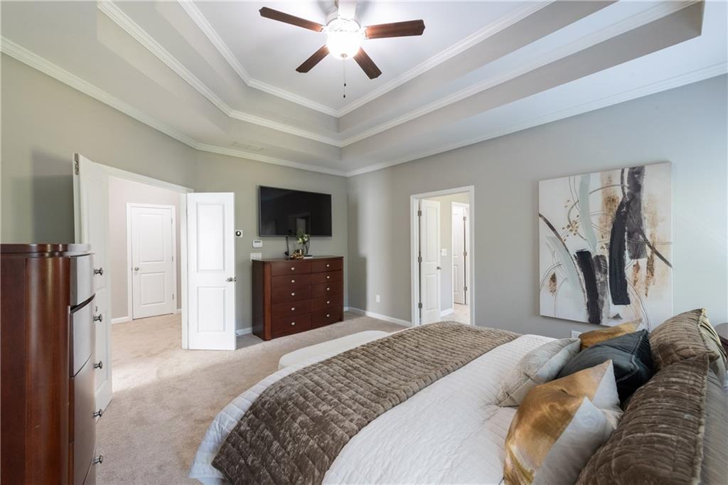 2199 Collins Ridge Drive Northwest Atlanta, GA 30318 - Photo 19 of 50 a bedroom with a bed and a flat tv screen on dresser