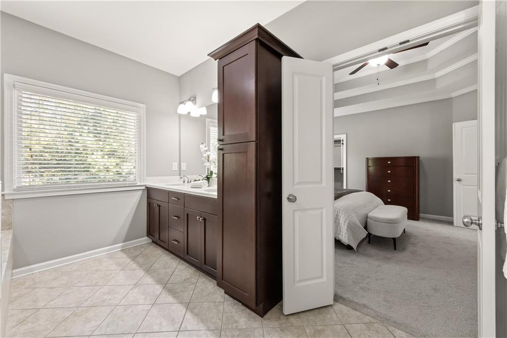 2199 Collins Ridge Drive Northwest Atlanta, GA 30318 - Photo 23 of 50 a bathroom with a tub sink and mirror
