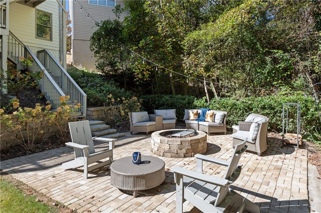 2199 Collins Ridge Drive Northwest Atlanta, GA 30318 - Photo 45 of 50 a view of a patio with a dining table and chairs and potted plants