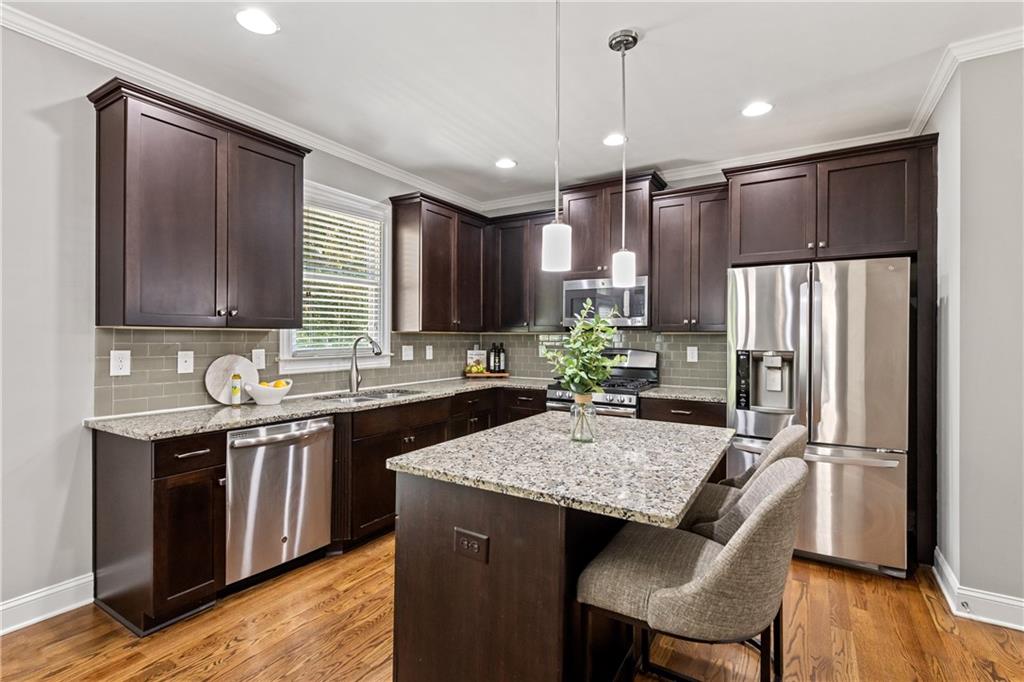 2199 Collins Ridge Drive Northwest Atlanta, GA 30318 - Photo 6 of 50 a kitchen with kitchen island granite countertop a sink stove and refrigerator